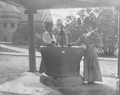 Getting water at the campus fountain on a spring day. Edith filling her cup on the right.
